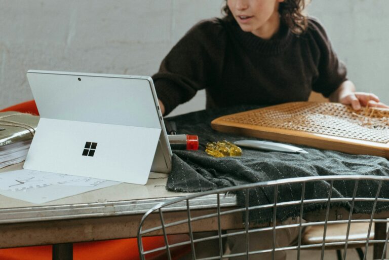 a woman sitting at a table with a laptop