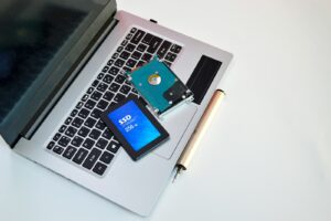 An open laptop computer sitting on top of a white table